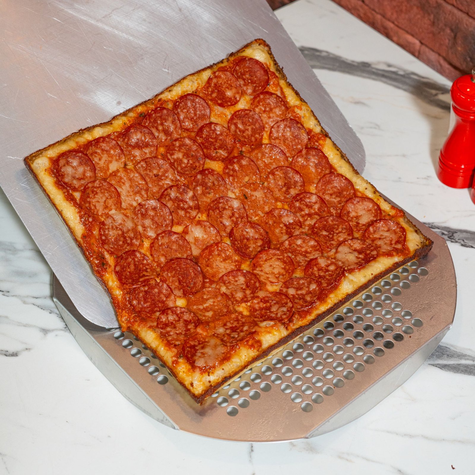Square Pepperoni Pizza on a Marble Counter