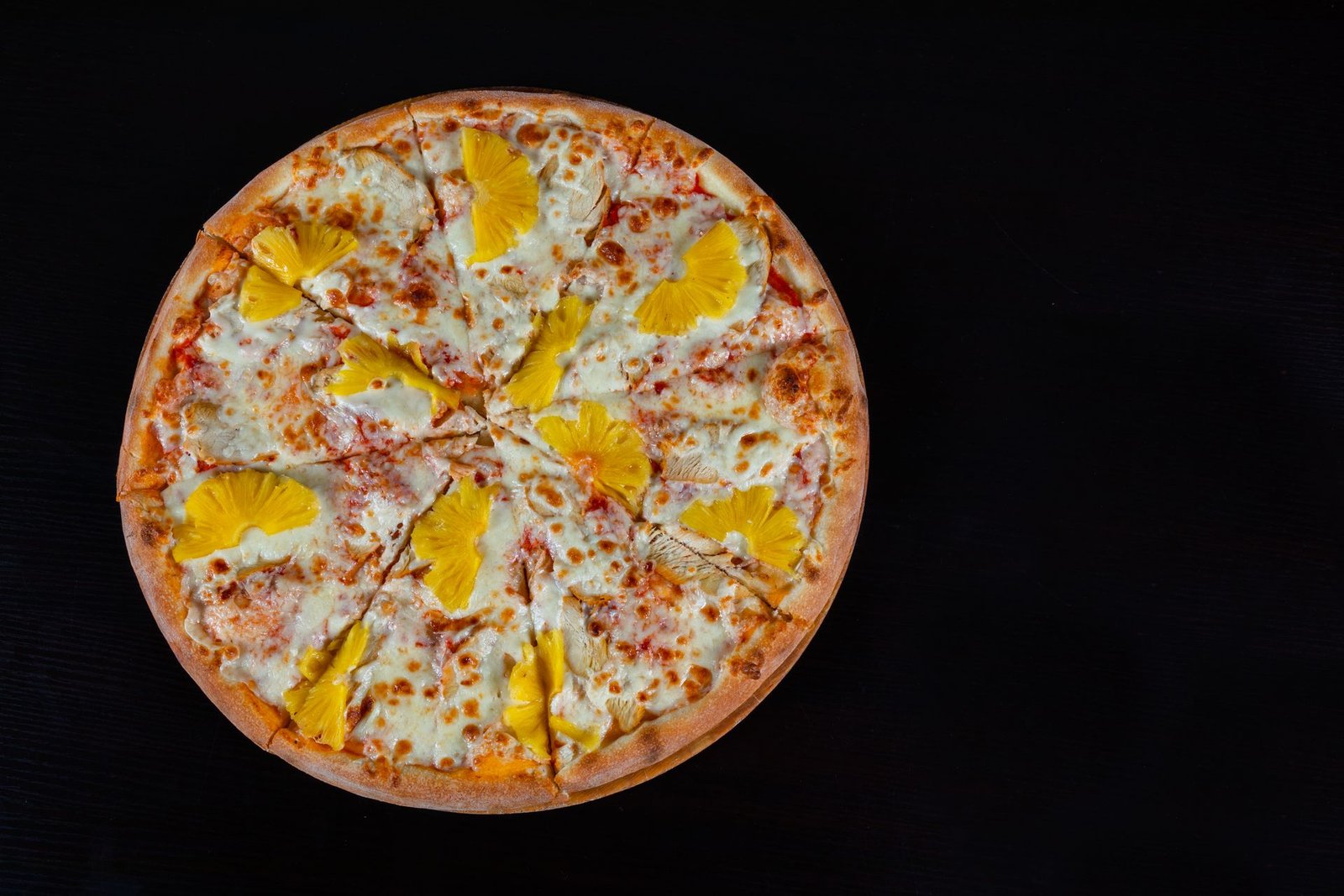 A pizza with cheese and eggs on top