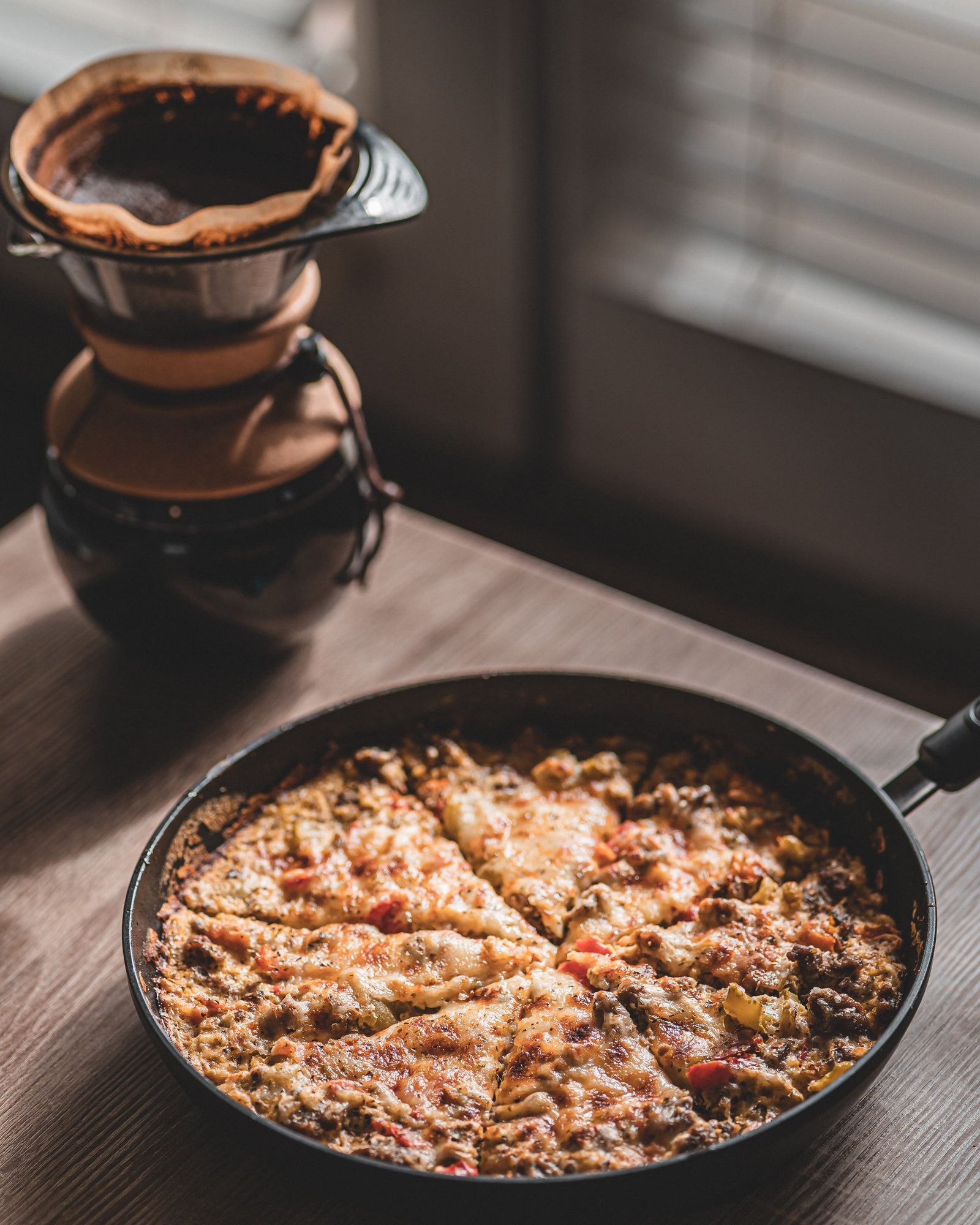 Black Round Pan With Pizza on Wooden Table