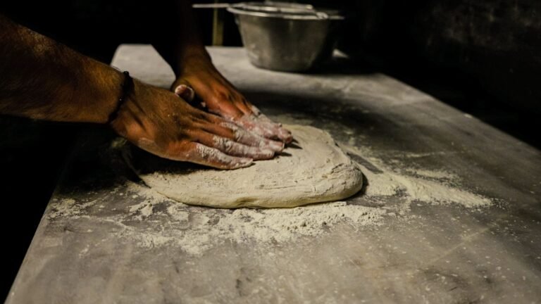 pizza chef kneads dough