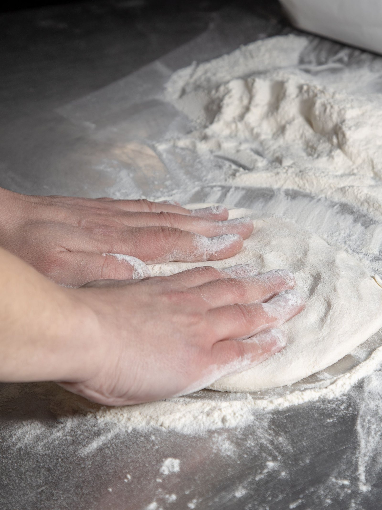 Person Preparing a Pizza