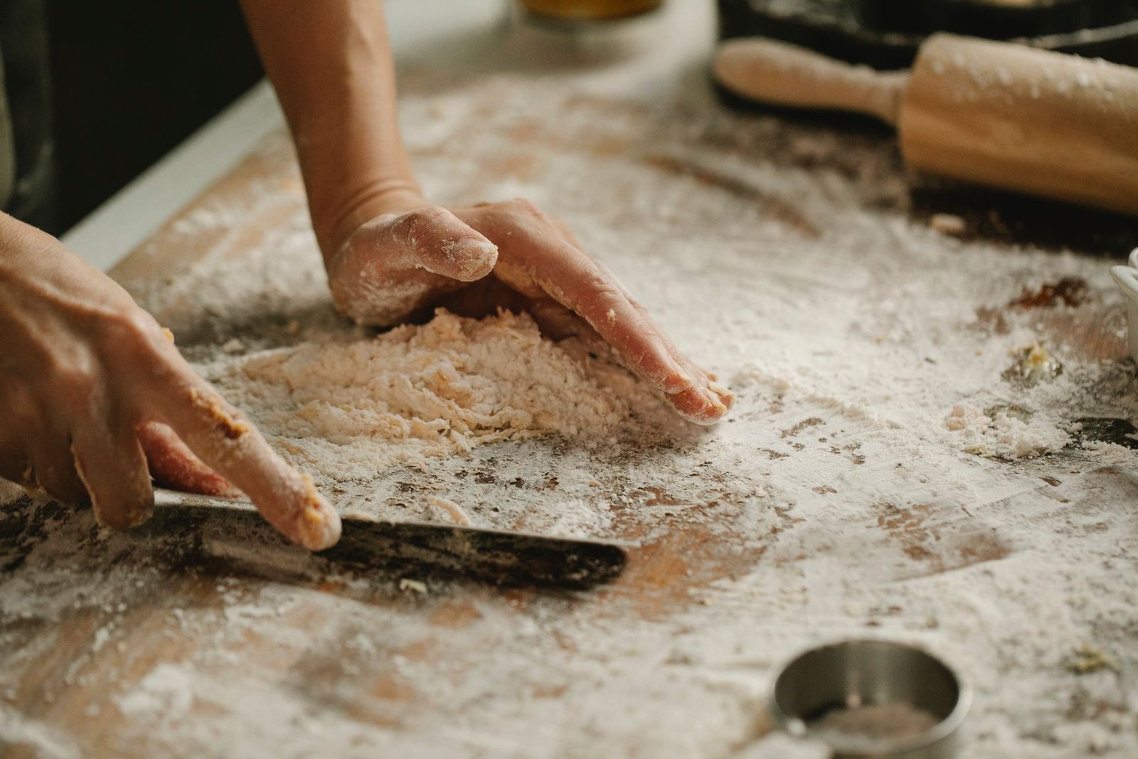 Chef cleaning cutting board with knife in kitchen