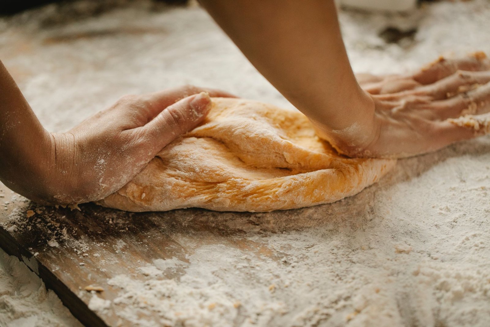 Chef making fresh pastry on table in bakery