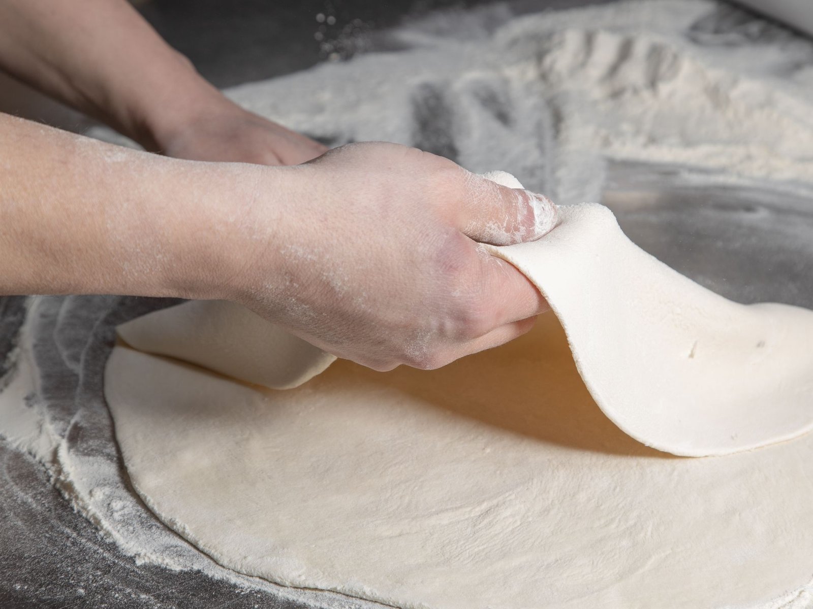Person Preparing a Pizza