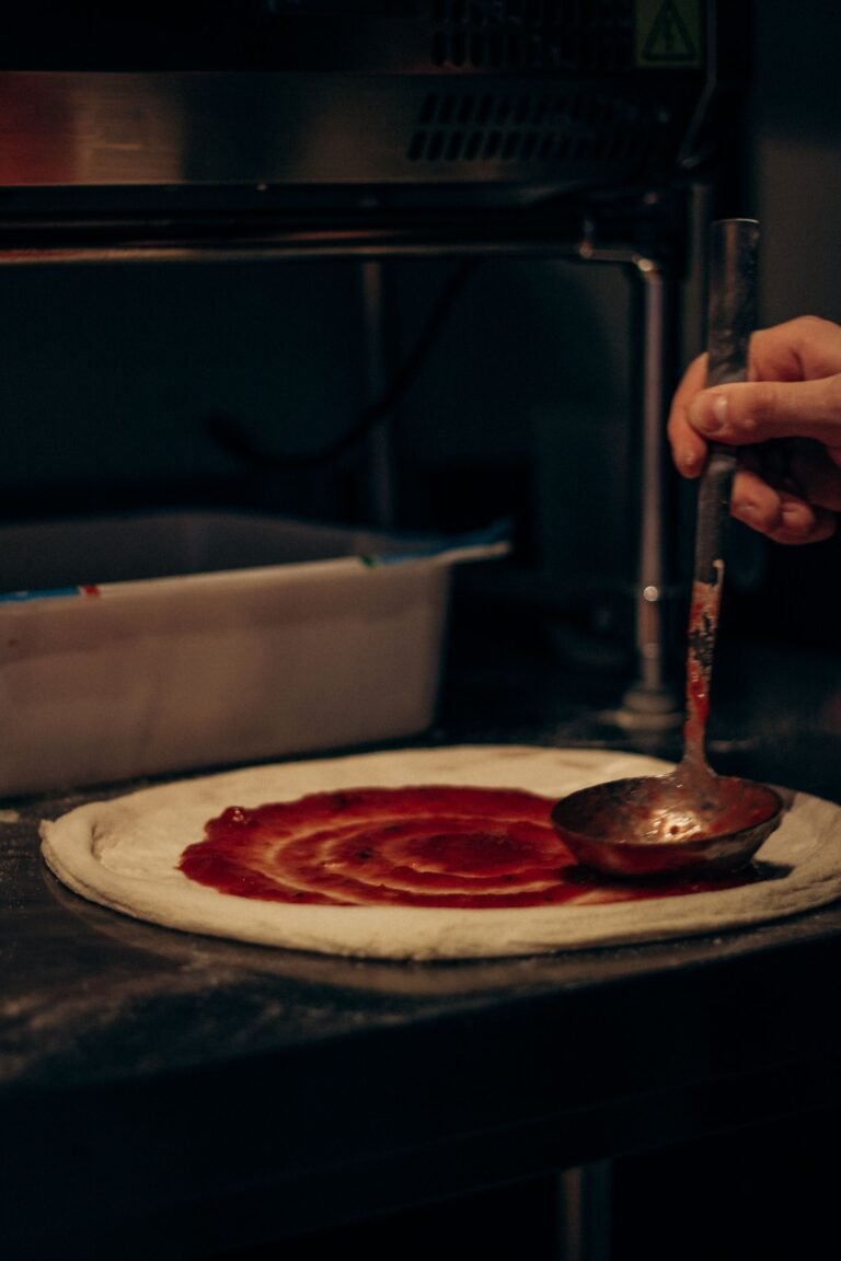 Close-up of Pizza Preparation in Kitchen