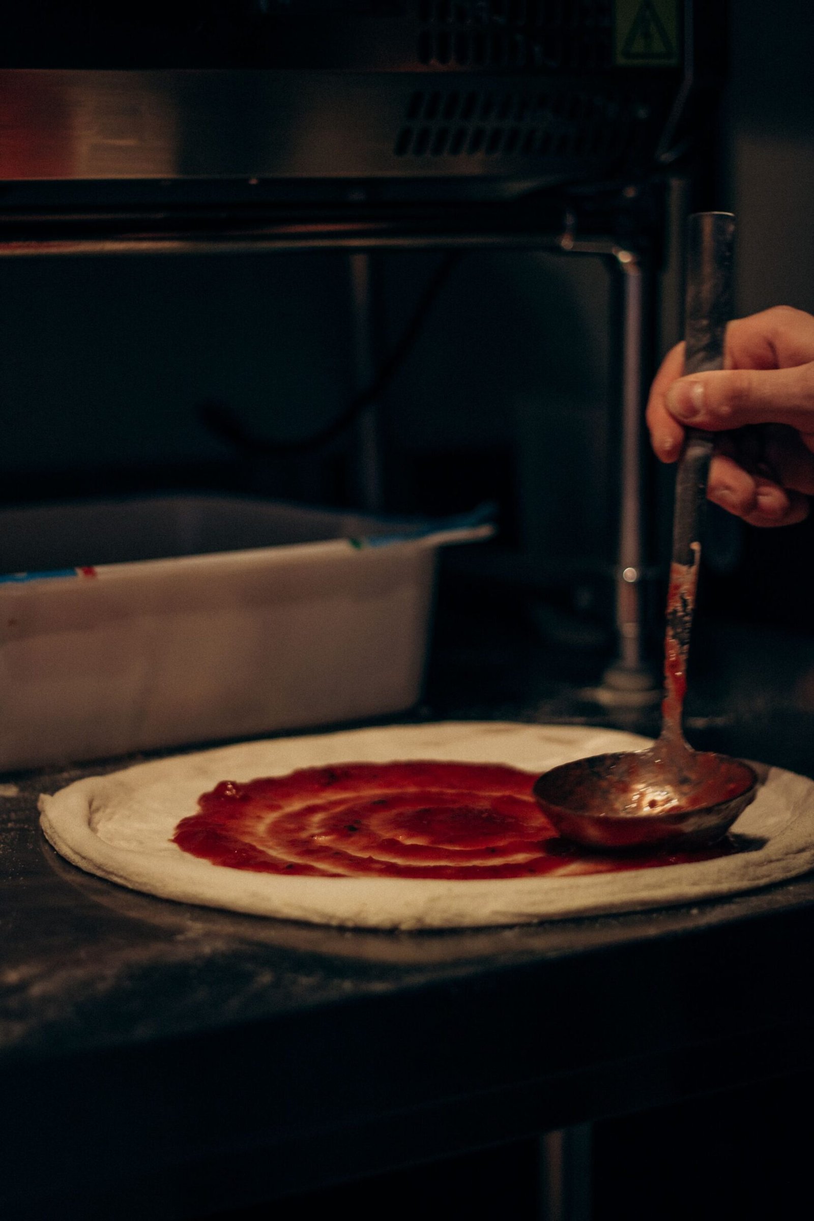 Close-up of Pizza Preparation in Kitchen