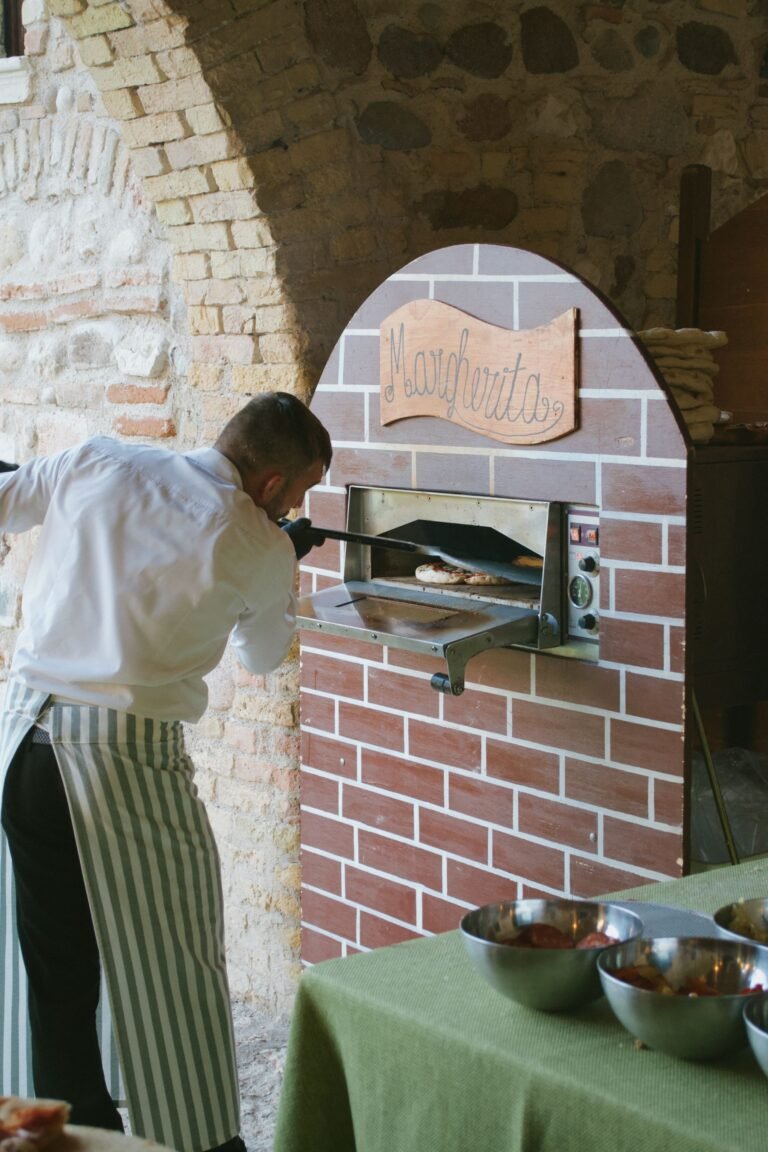 Chef Baking Pizza in Traditional Brick Oven