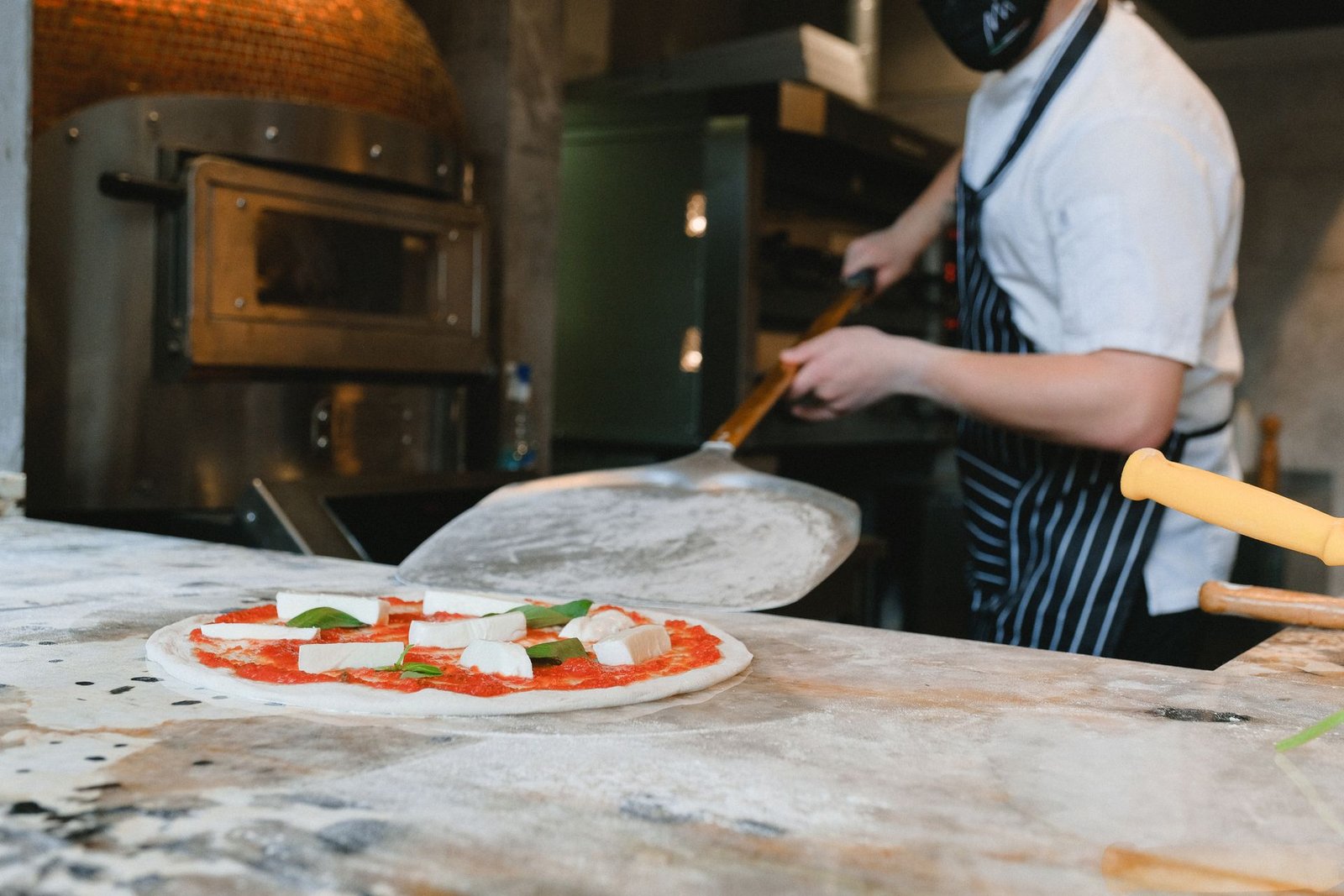 Cook Preparing Pizza