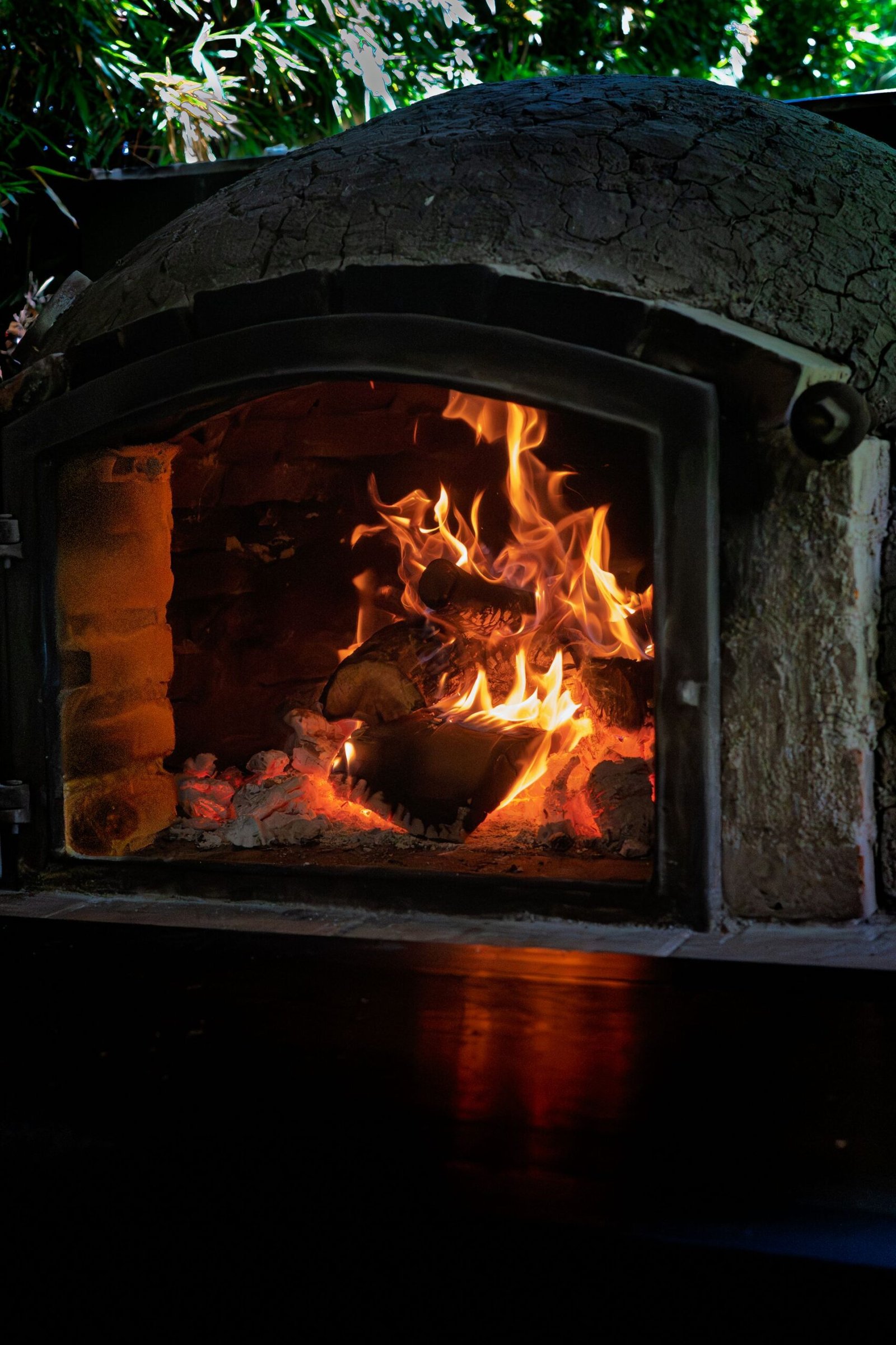 Rustic Outdoor Pizza Oven with Burning Firewood
