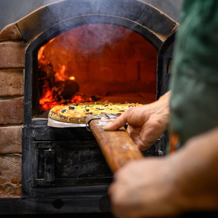 Artisanal Pizza Baking in Traditional Wood-Fired Oven