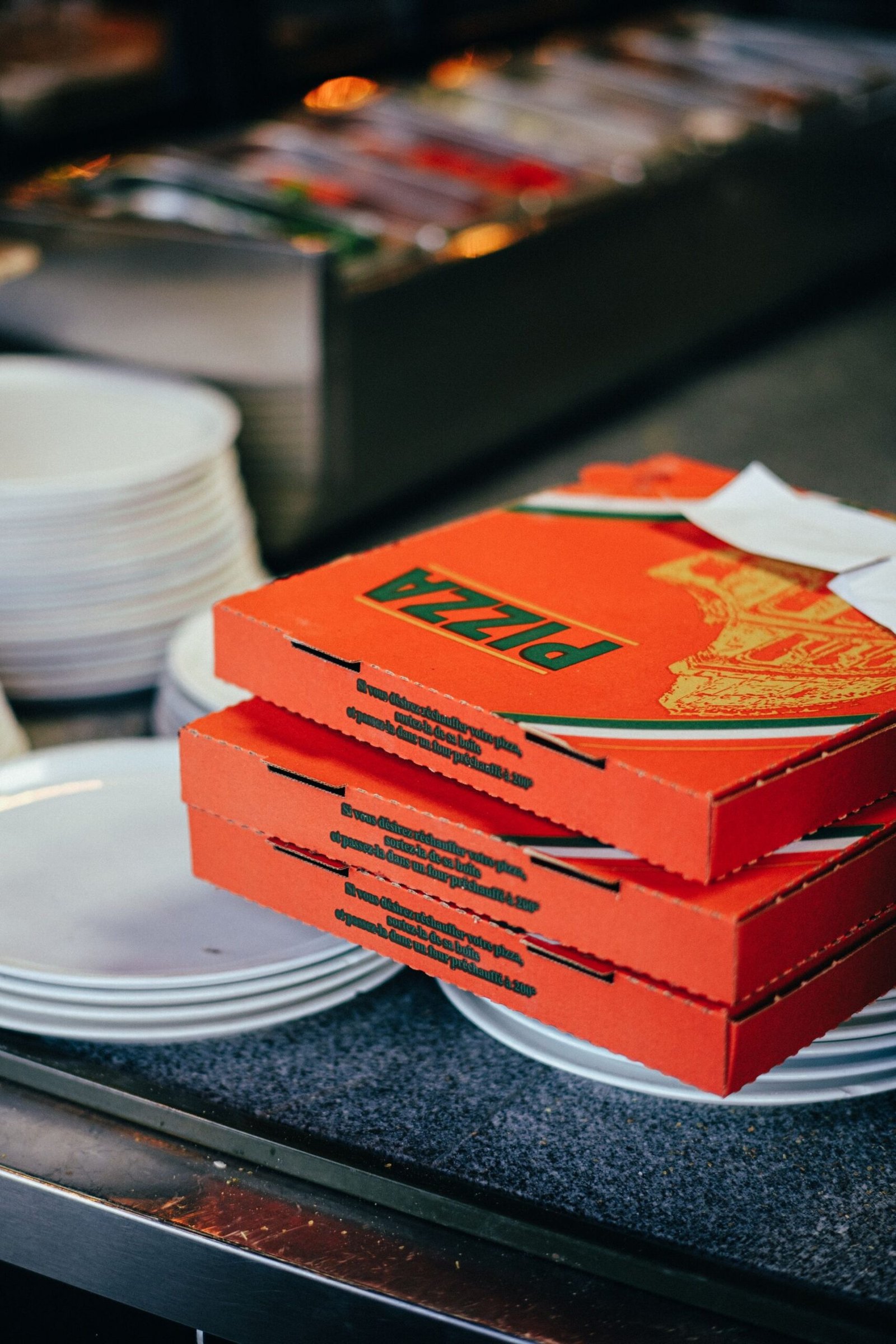 Pizza Boxes on Top of Ceramic Plates