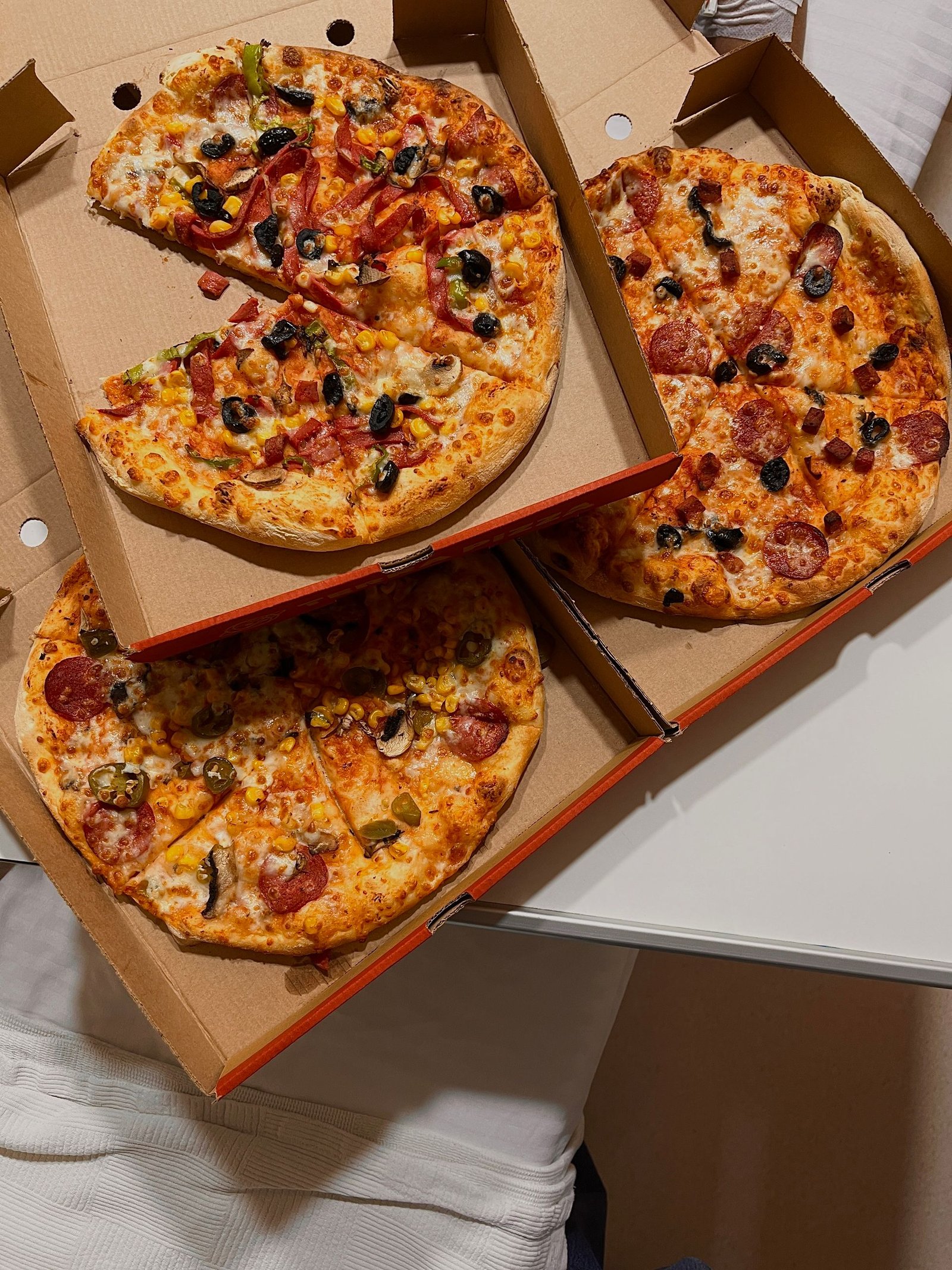 Delicious Assorted Pizzas in Cardboard Boxes