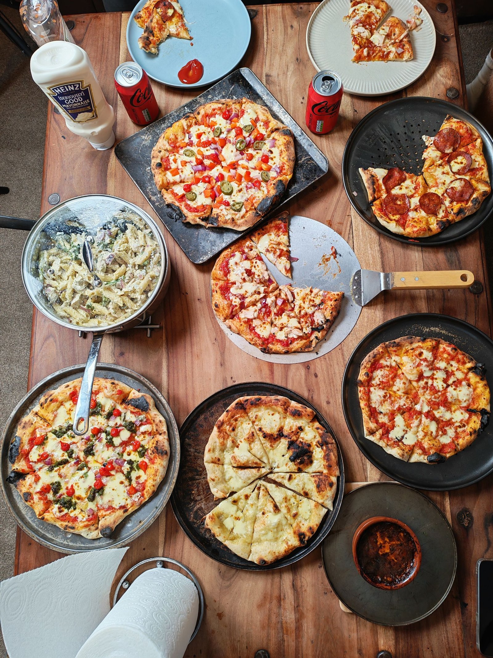 Delicious Assorted Pizzas and Beverages on Table