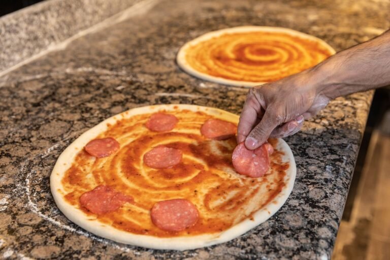 A Person Preparing Pepperoni Pizza