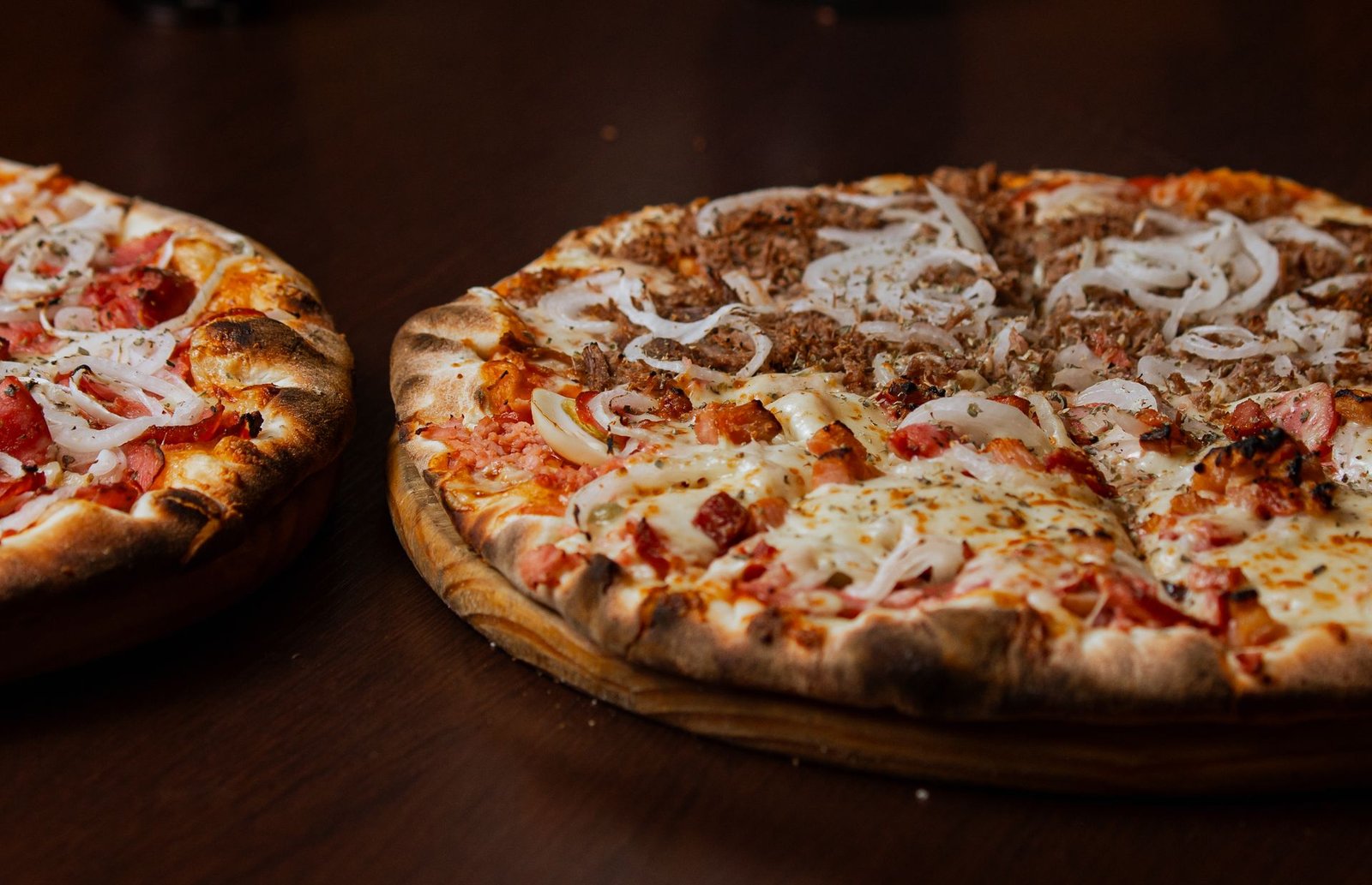 Delicious Pepperoni and Onion Pizza on Wooden Table