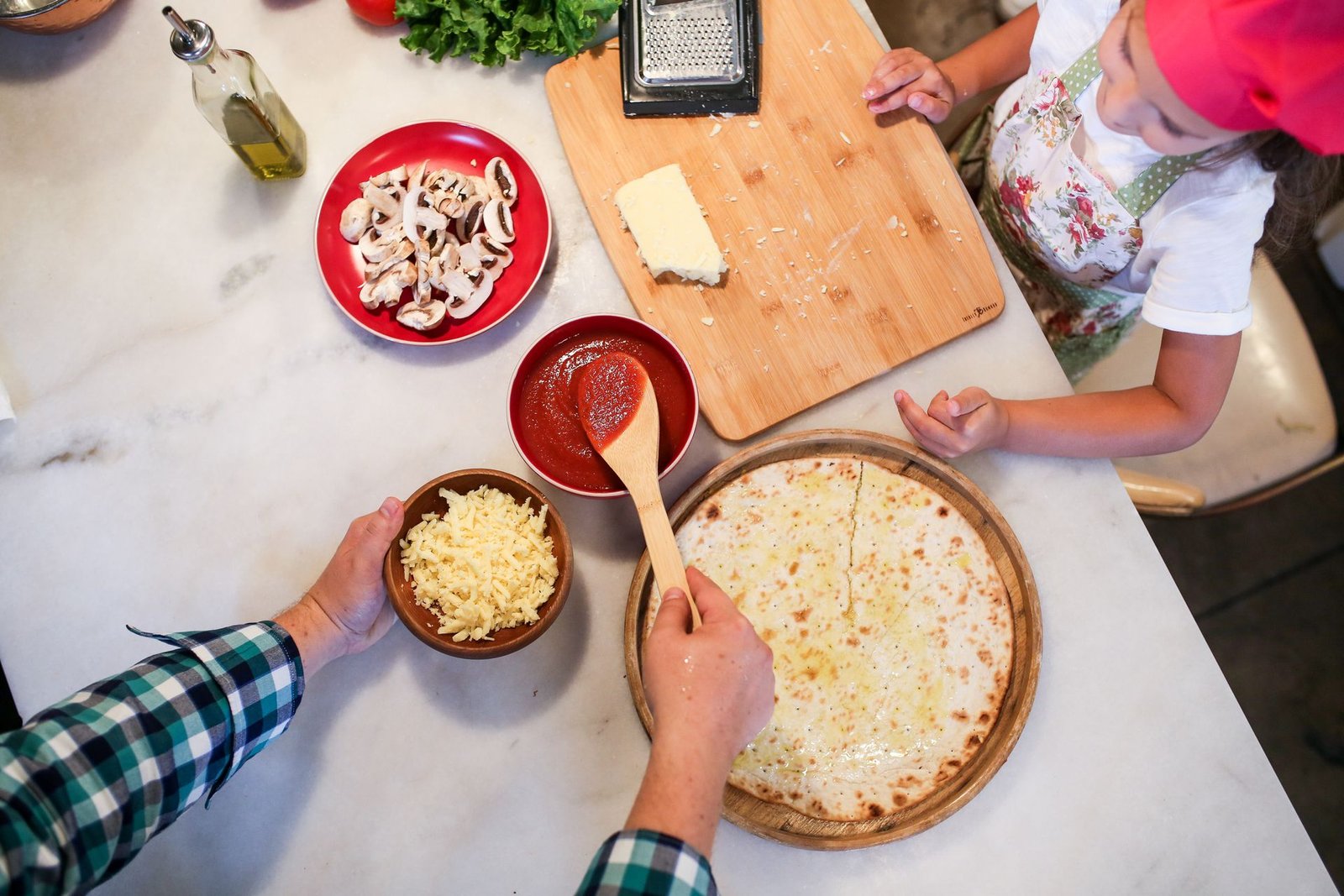 Father and Daughter Preparing Pizza on Kitchen Counter Table
