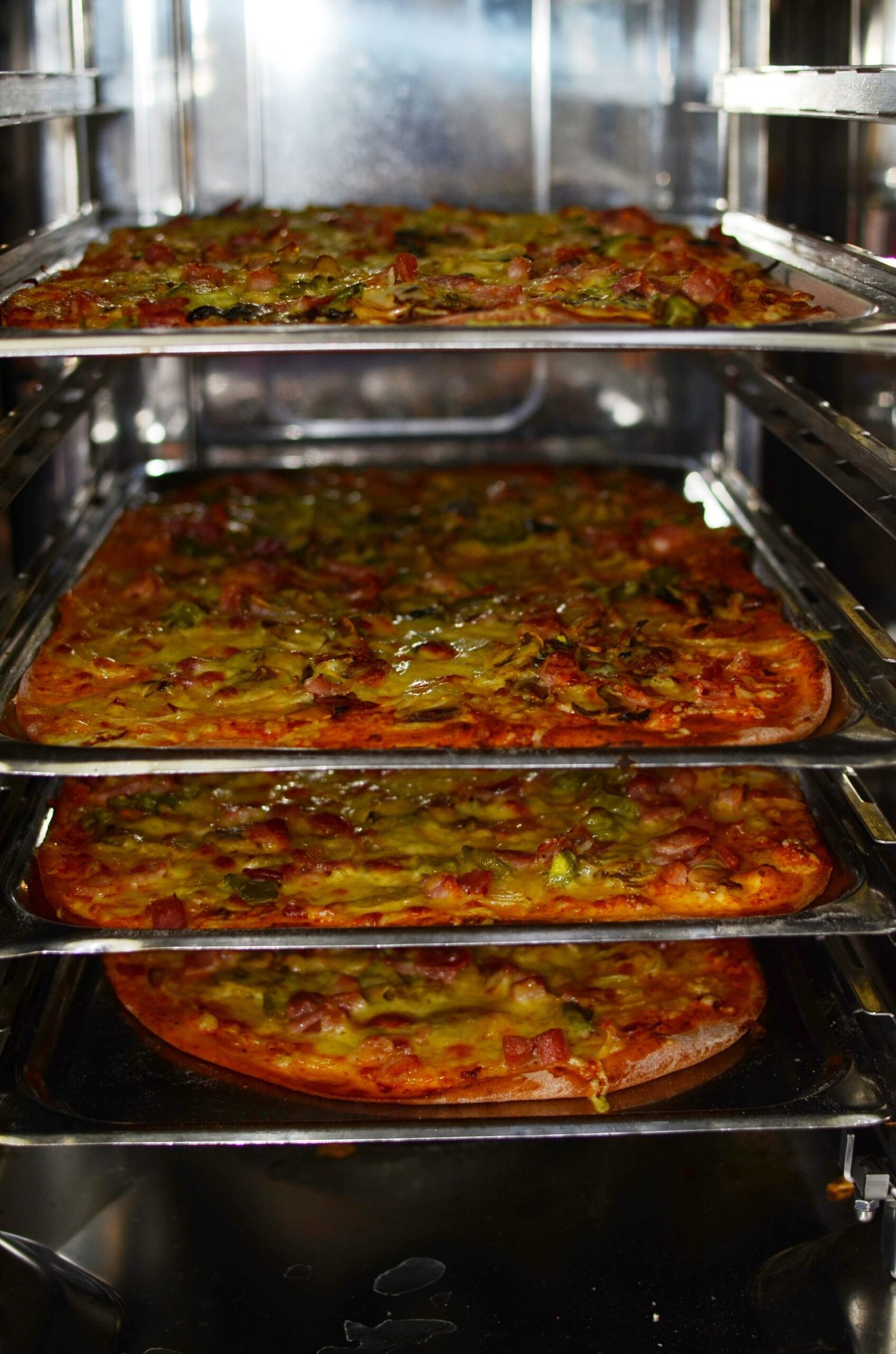 Delicious pizzas baking in an industrial oven
