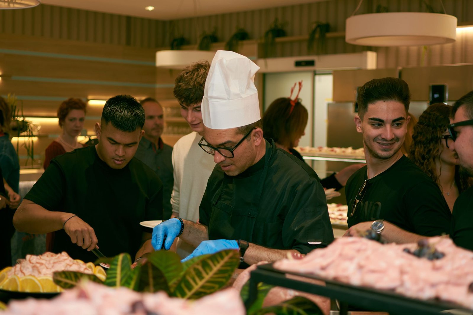 Chef serving guests at a vibrant buffet event
