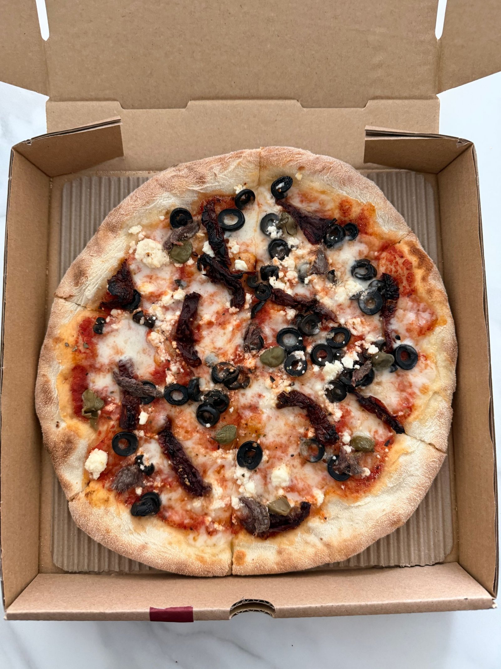 Mediterranean Pizza in Cardboard Box
