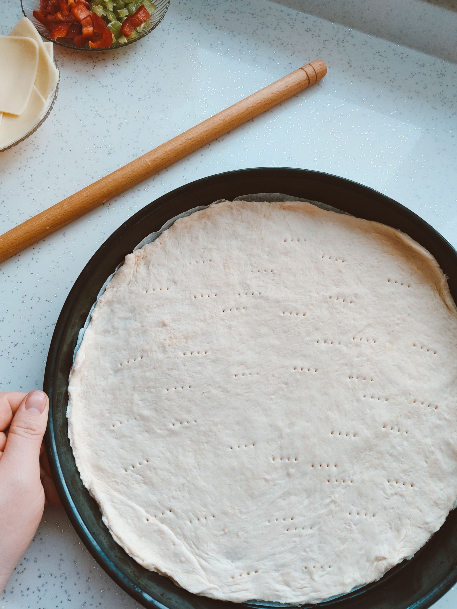 Flat Lay of Unbaked Pizza Dough with Ingredients