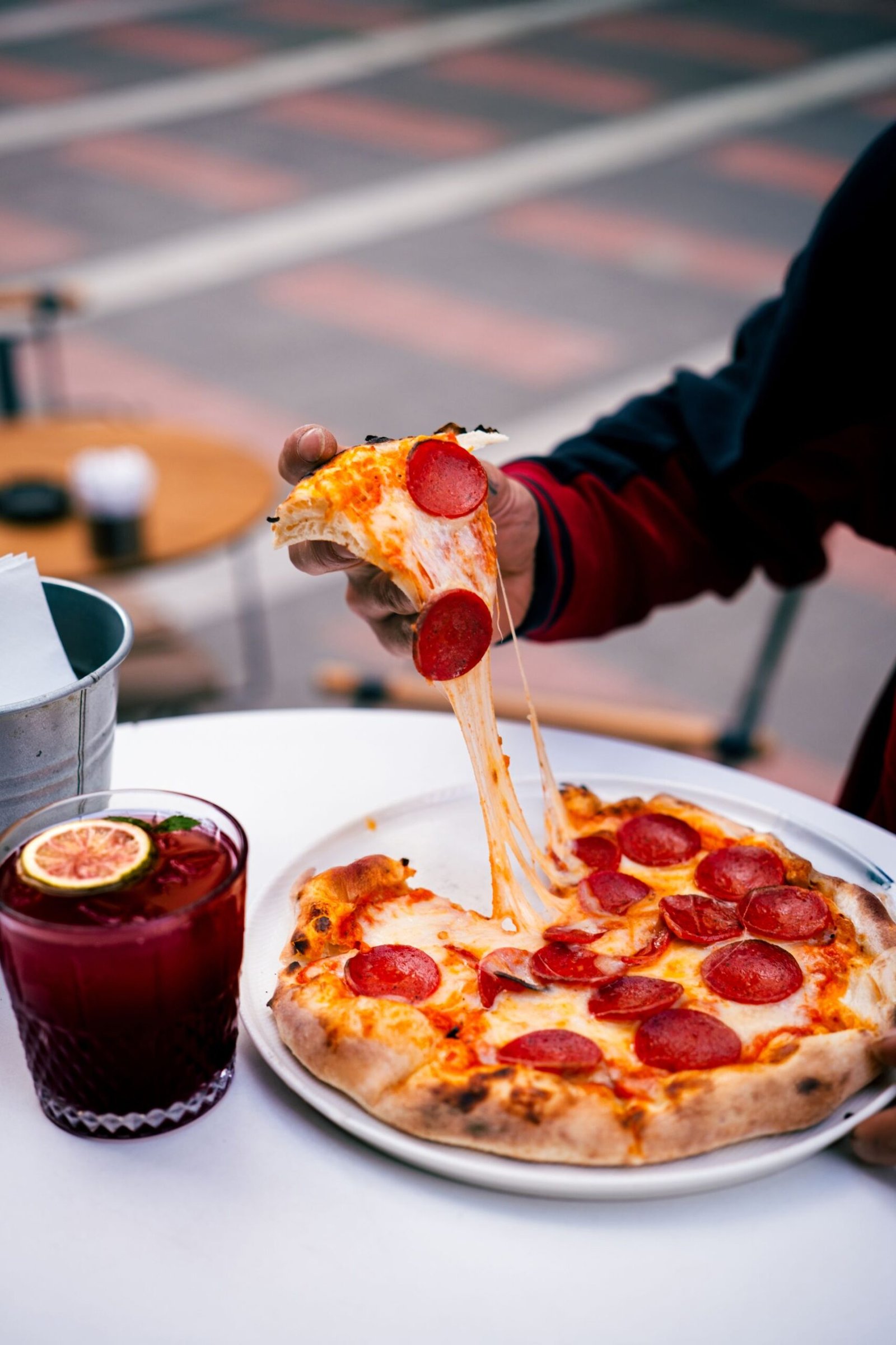 Delicious Pepperoni Pizza with Refreshing Drink Outdoors