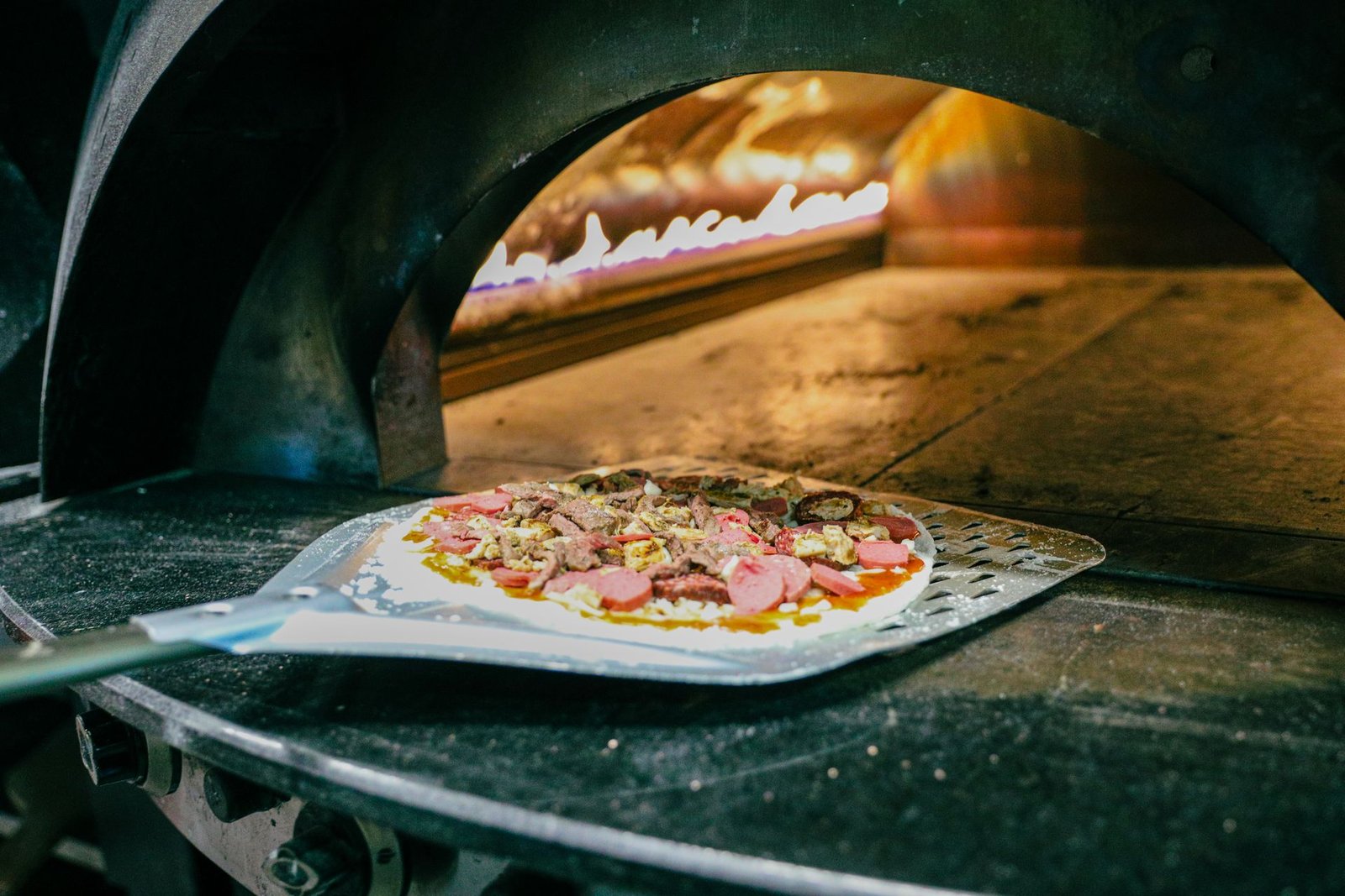 Wood-Fired Pizza Baking in Stone Oven